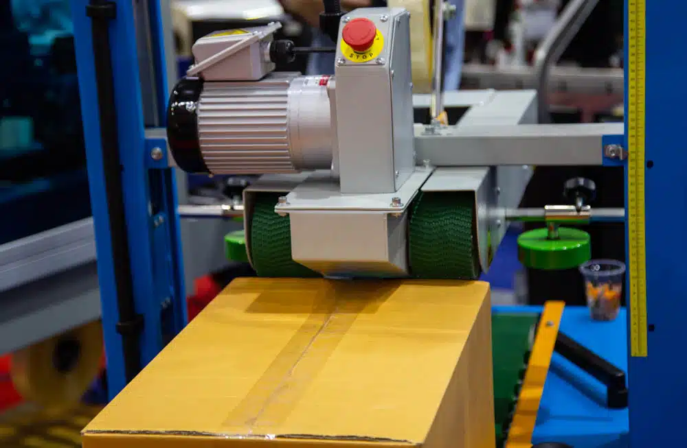 Automatic taper seals a package with masking tape