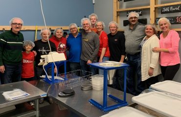 Simmons' employees and their family members pose for a picture at the Feed My Starving Children volunteering event.
