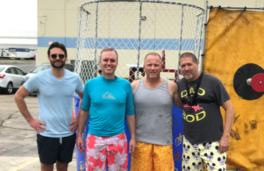 Simmons' management team poses for a picture in front of a dunk tank in Simmons' parking lot in Glendale Heights, IL.