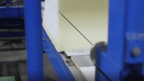 A Simmons CNC blade cuts through polyurethane foam.