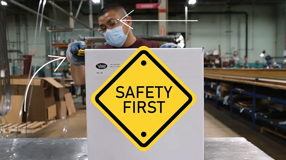 A Simmons' employee uses a box cutter to open a box containing bandsaw blades while taking proper safety measures.